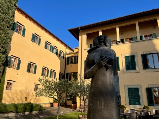 Library facade, garden, and statue. 