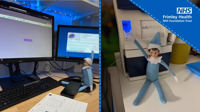 Two side-by-side images showing an elf doll positioned in office settings. On the left, the elf sits by a computer and notepad on a desk with dual monitors. On the right, the elf is next to medical equipment with 'Frimley Health NHS Foundation Trust' visible in the background.