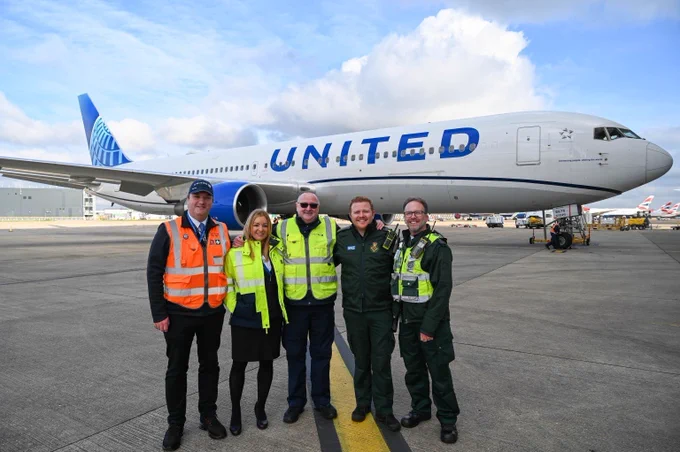 John, United Airlines staff and LAS clinicians in front of an aircraft. 