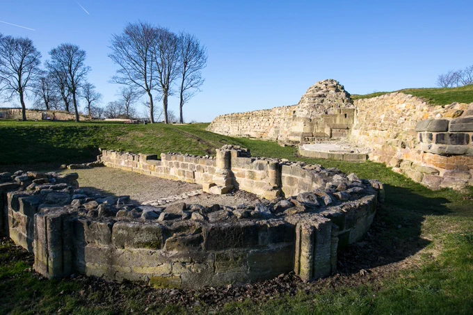 Part of the remains of a chapel at Pontefract Castle with wintry trees in the background
