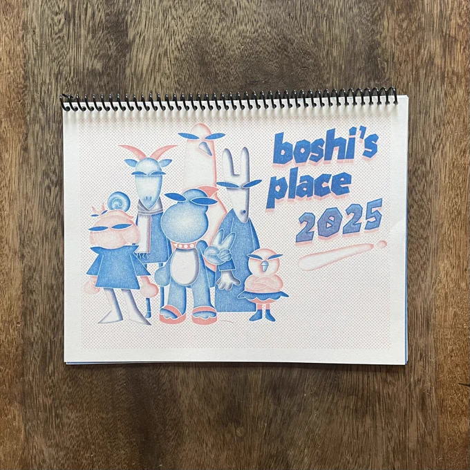 a spiral-bound calendar lies on a wooden table, on the cover is a blue and coral risograph print with 6 anthropomorphic animal characters drawn in a visual style evoking avant-garde punk fashion, featuring spikes and sunglasses. to the left of the crew, "boshi's place 2025" is written in big blue knockout text, overlaid on the dithered coral background. 