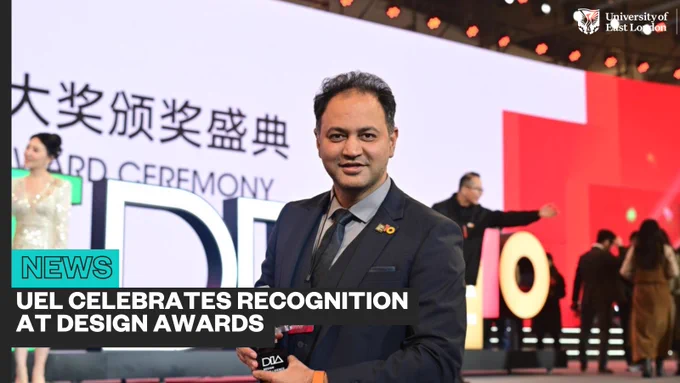 Person holding an award at the design awards ceremony, with attendees and event signage in the background. Text reads 'News: UEL celebrates recognition at Design Awards'.
