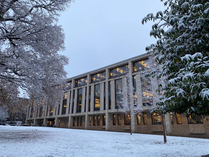 Image shows exterior of the library building covered in snow