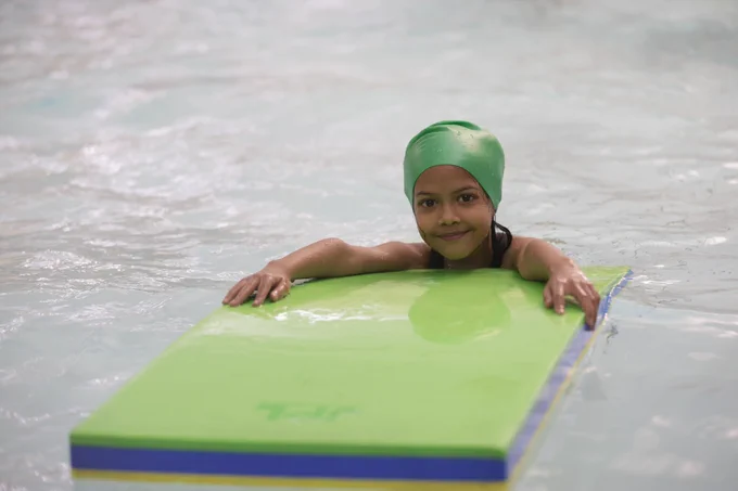 Young child enjoys a swimming session. 