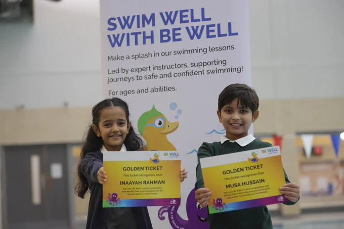 Mascot competition winners pose with certificates. 