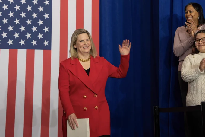 AFL-CIO President Liz Shuler waves as she walks up to a podium to speak at the Frances Perkins homestead national monument dedication ceremony at the Department of Labor headquarters in a Washington, DC