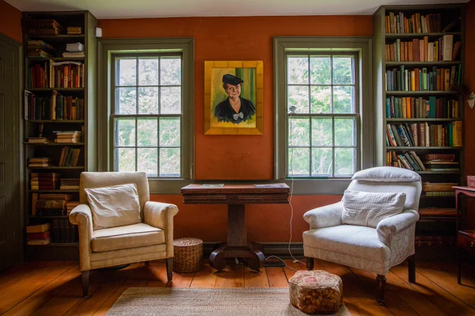 Interior view of Perkins home showing portrait of Frances Perkins above two armchairs flanked by bookcases.