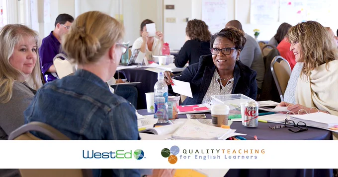 Professionals at a WestEd Quality Teaching for English Learners workshop engaged in discussion around a table.