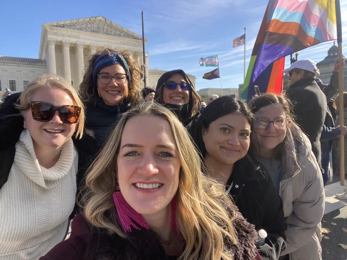 [image description: group selfie of Planned Parenthood advocates smiling while rallying for Trans Youth in front of the U.S. Supreme Court.]