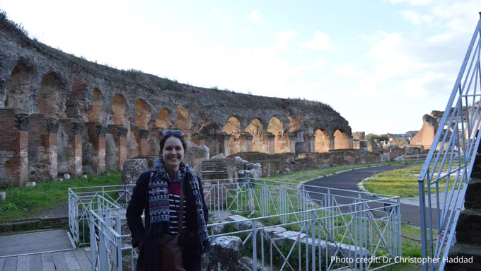 Dr Katherine McDonald standing in the amphitheatre in Capua, Italy.