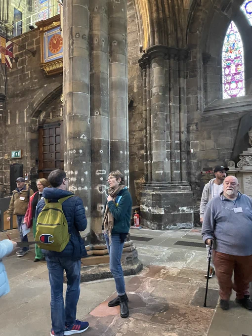 People stand and chat in Glasgow Cathedral.