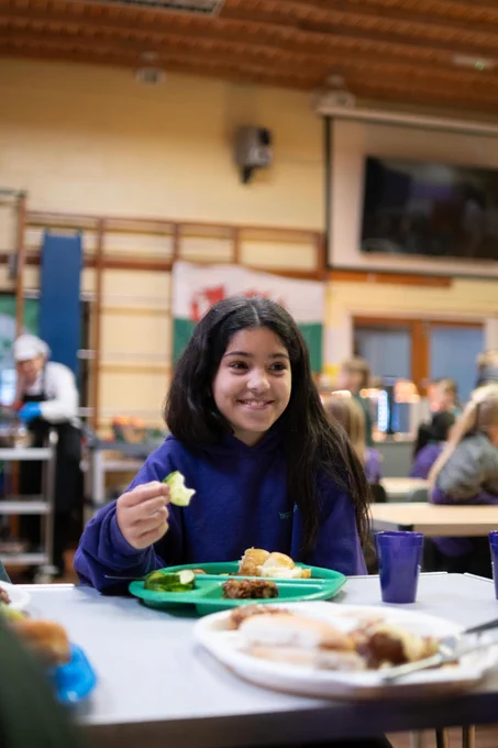 Primary school learner enjoying a school meal in the canteen.