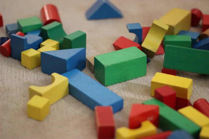Image shows lots of wooden blocks of various shapes and colours, all waiting to be sorted and organised.  Or played with.  Either way, it's a visual metaphor for 'data management'.