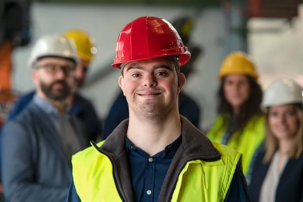 A young man with Down syndrome working in an industrial factory.