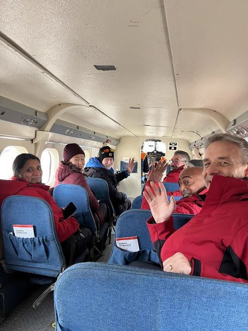 Clerk Hannaford and others wave to the camera inside an airplane.