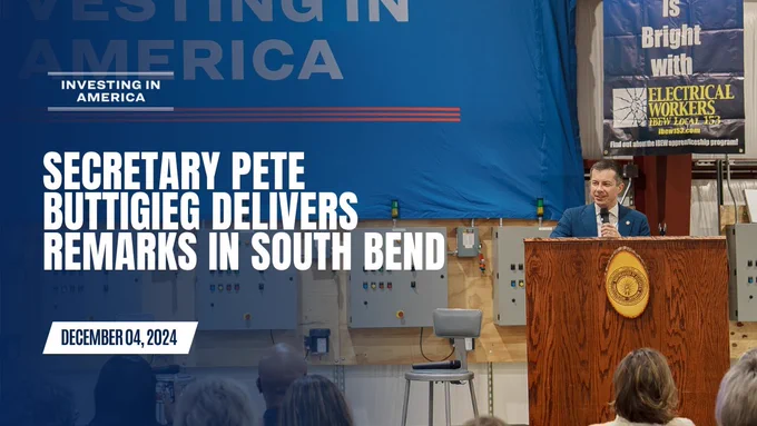 Image is of Secretary Pete Buttigieg at a podium delivering remarks. The text on the graphic reads: Investing In America. Secretary Pete Buttigieg delivers remarks in South Bend, IN at an IBEW Training facility. December 06, 2024.