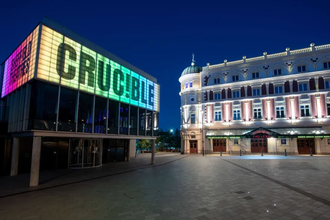 Sheffield Theatres at night, with "CRUC!BLE" lit up