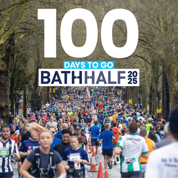 Participants running in the 2024 Bath Half Marathon surrounded by leafy trees.

There is text overhead that reads '100 Days to Go'.