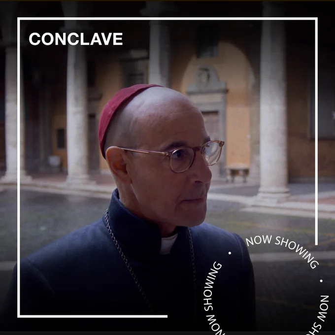 Stanley Tucci dressed as a member of the Catholic Church Conclave. Text - Conclave, Now Showing.
