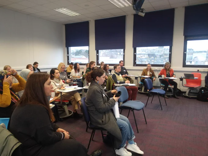 Seminar attendees are sitting in the audience and listening to the speaker