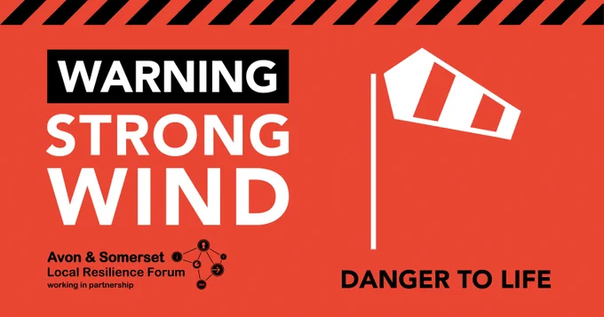 Warning strong wind written in white on a red background. Windsock depicting strong wind above text reading danger to life
