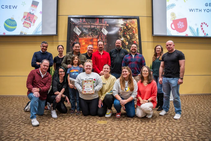Faculty and staff from the UCF Department of Criminal Justice standing together and smiling while holding the fan favorite award.
