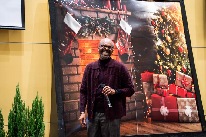 Grant Hayes, Ph.D., dean of the UCF College of Community Innovation and Education is smiling while giving a speech at the college's holiday gathering.
