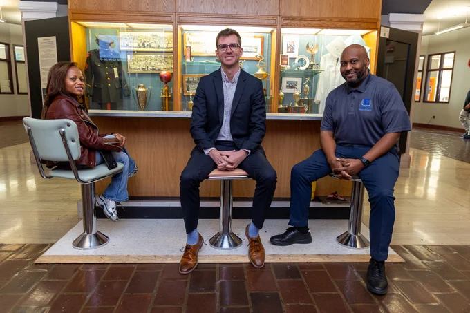 Photo of Dr. Lumumba-Umoja, Principal Miller, and Assistant Principal Cureton at Eastern High School. 