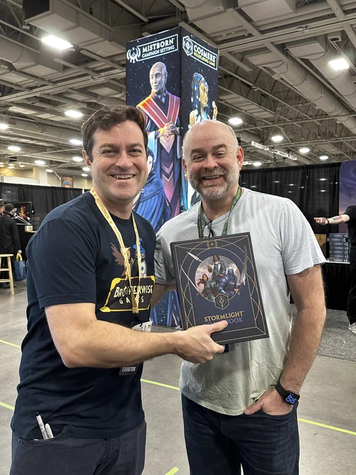 Chris and Johnny O’Neal holding the Stormlight Handbook!