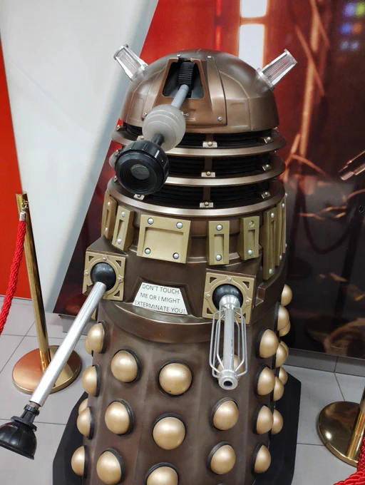 Picture of a dalek. It has a sign saying "do not touch or I might exterminate you"