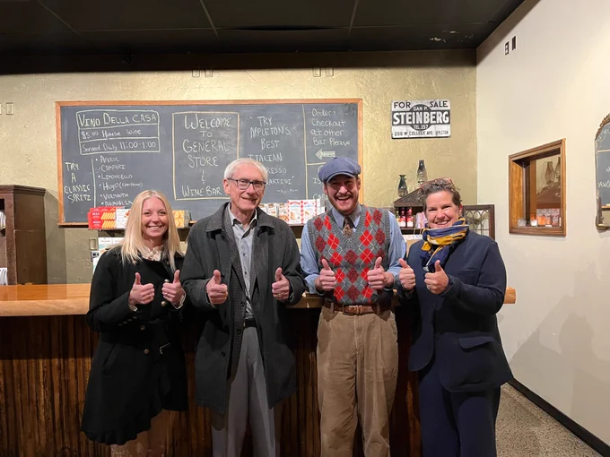 Gov. Evers poses with Sec. Hughes and local business owners. 
