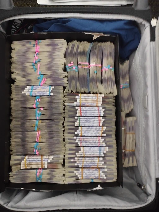 Stacks of seized cash in a suitcase