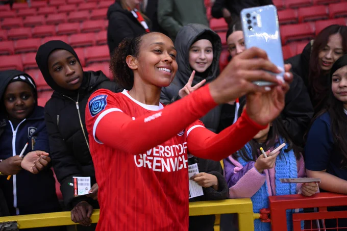 Atlanta Primus of Charlton Athletic poses for a selfie with fans.