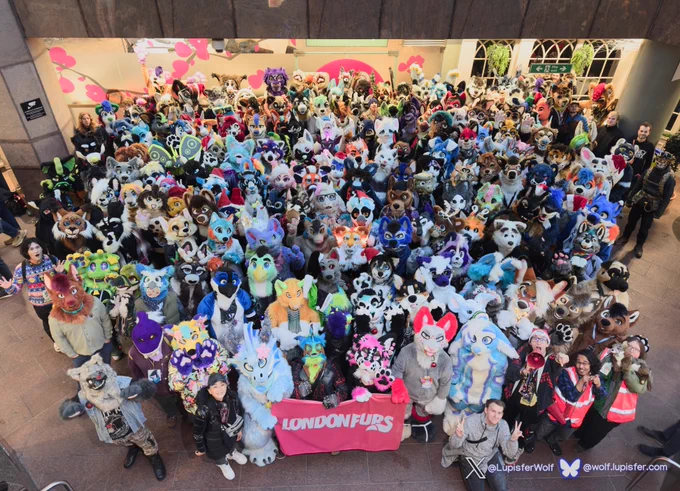 LondonFurs group photo containing a large collection of furries in different colours.