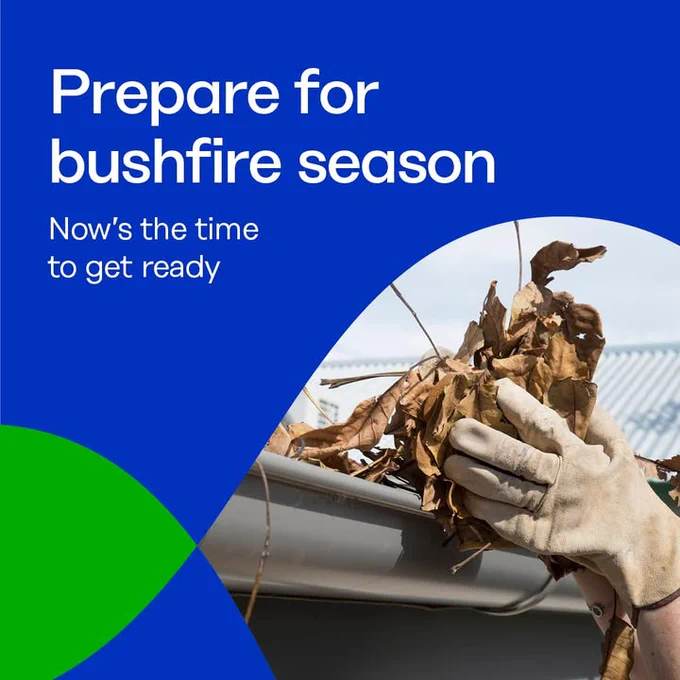 Promotional image encouraging preparation for bushfire season, featuring hands clearing dried leaves from a gutter, with text 'Prepare for bushfire season - Now's the time to get ready' overlaid on a graphic design of blue sky and a green circle.