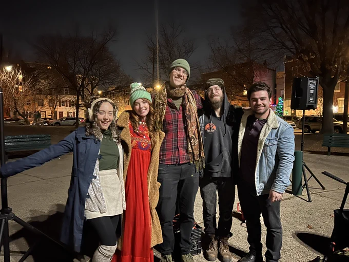 Group photo of local band Miss Cantaloupe after performing at the Winter Holiday Singalong in Konrad Square