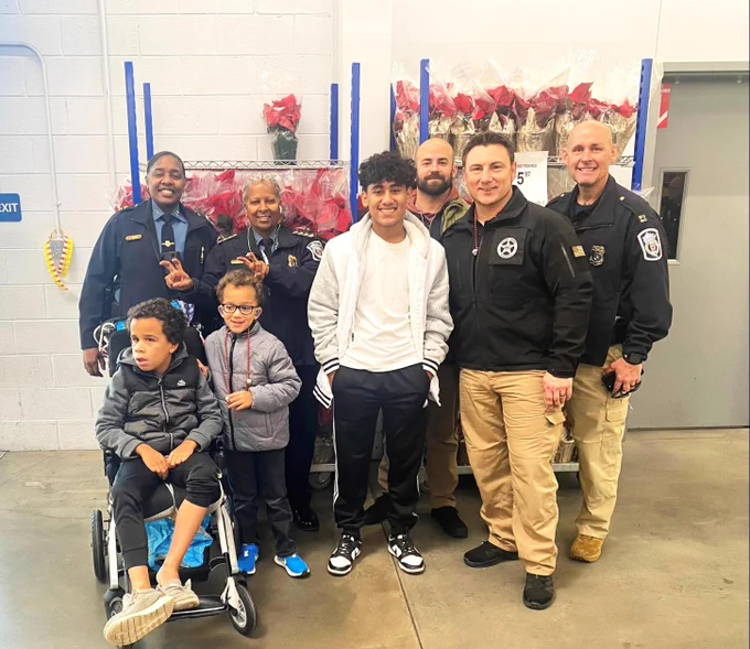 Officers from Anne Arundel County Police Department pose with deputies from the U.S. Marshals Service and participants of the Shop with a Cop program. 