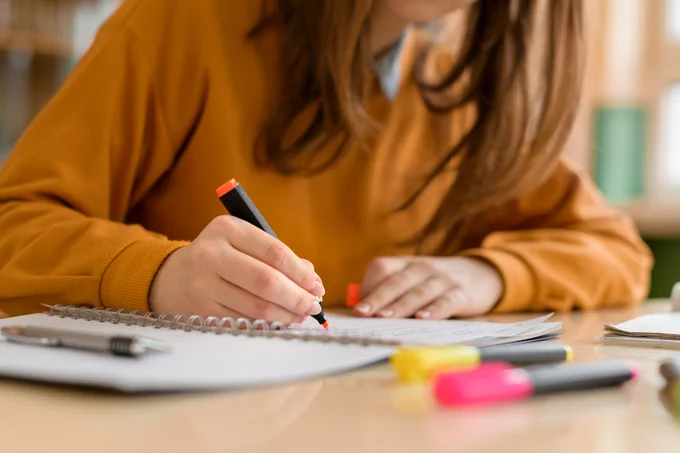 Student working on notes with highlighter 