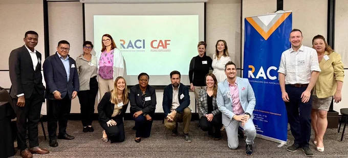 Members of the CAF International Network gathered together and smiling at the camera.