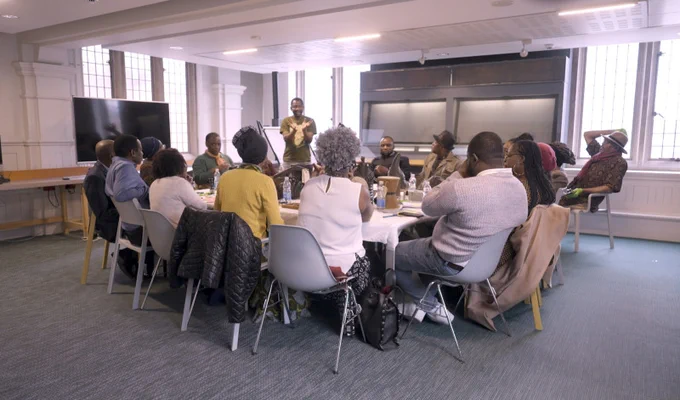Group sat around table, Dr. Njabulo Chipangura facilitating
