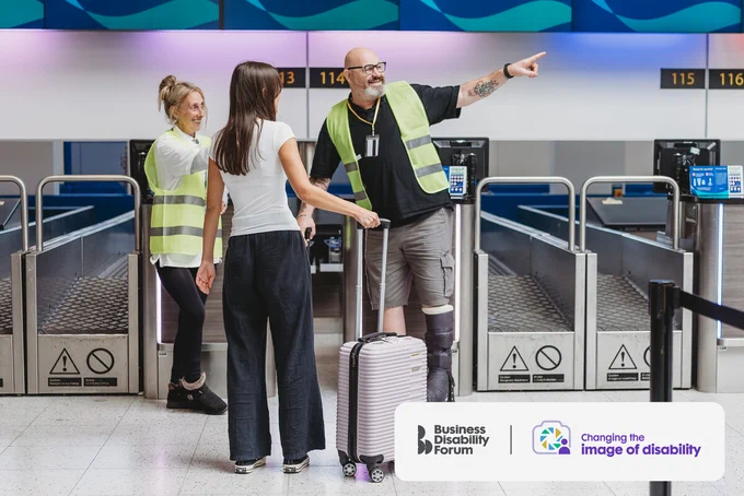 Airport worker wearing a medical boot and using a cane and a colleague give directions to a passenger. The Business Disability Forum 'Changing the image of disability' logo is in the lower right corner of the image.