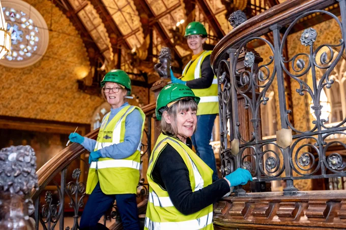 Construction workers painting the staircase.
