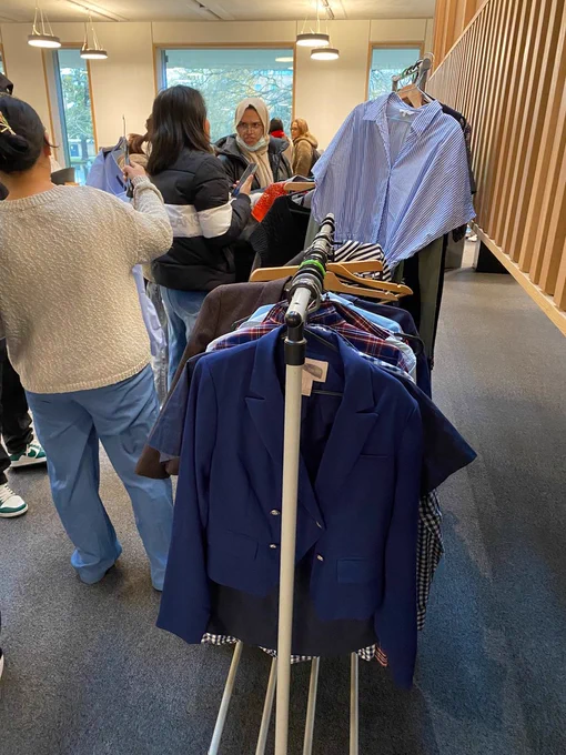 Image shows students looking at the clothing