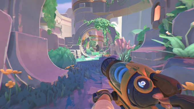In game screenshot shows an overgrown path. Beatrix is surrounded by what looks to be dilapidated ruins. The vacgun is prominently featured in shot.