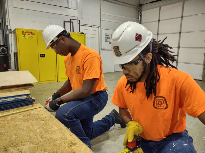 Two Job Corps students work side by side in the Carpentry program.