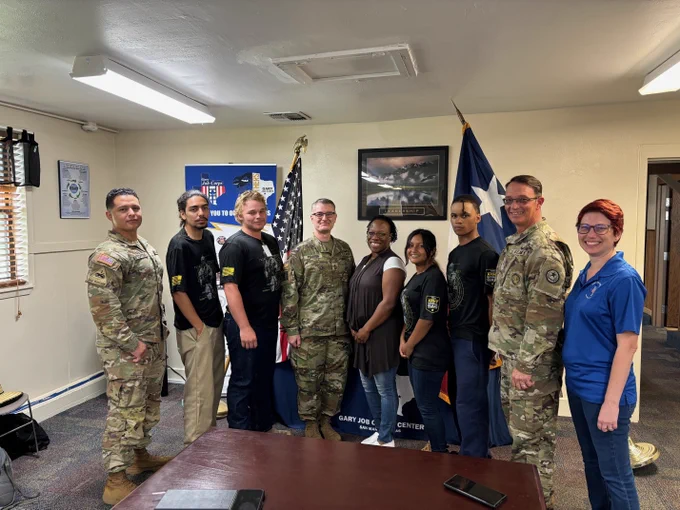 Nine Texas Army National Guard Personnel, Future Gary Job Corps Soldiers, and Job Corps Management Staff pose for a photo.