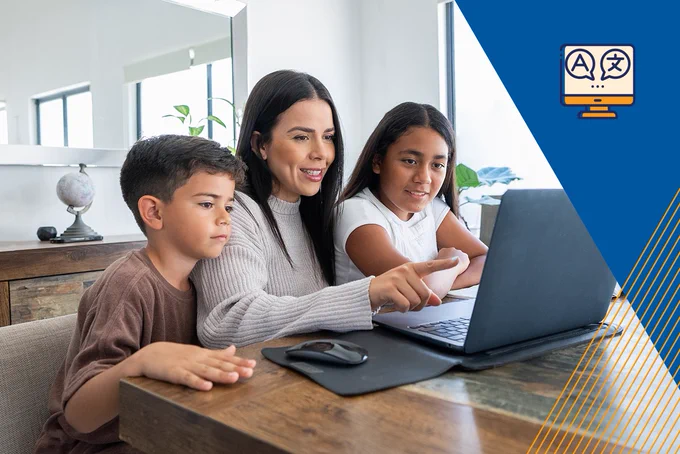 A mother and her two children sitting together and looking at a laptop.