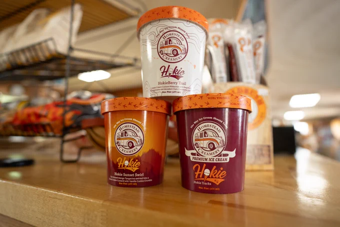 Three pints of Hokie ice cream, showcasing each specialty flavor, sit stacked on a countertop