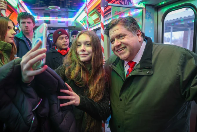 Governor Pritzker takes pictures with constituents on the Holiday Train.