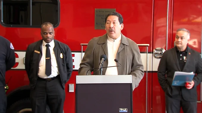 Mayor Bruce Harrell speaks with Dr. Umair A. Shah, Washington State Secretary of Health and Harold Scoggins, Seattle Fire Department Chief in the background.